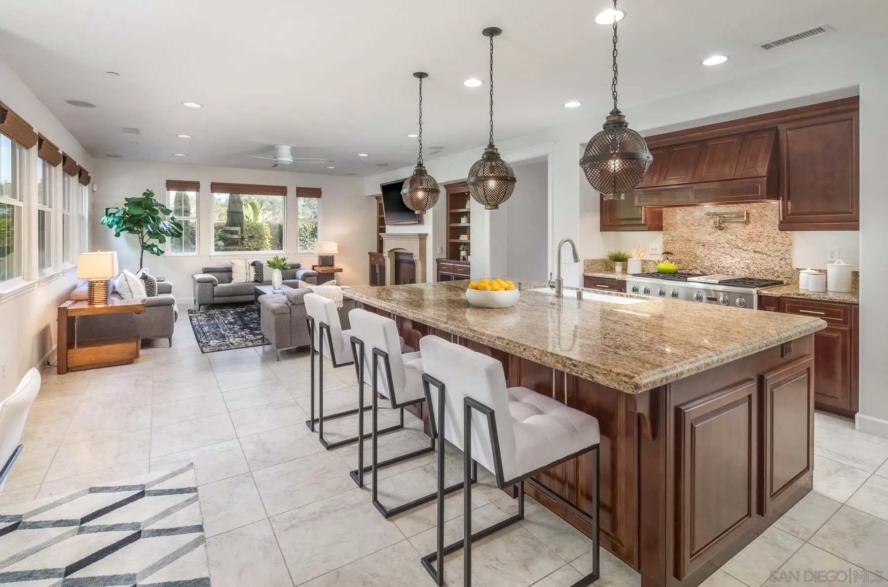 548 Quail Pointe Lane Encinitas, CA 92024 - Photo 8 of 30 a kitchen with granite countertop kitchen island stainless steel appliances a large center island attached withe living room