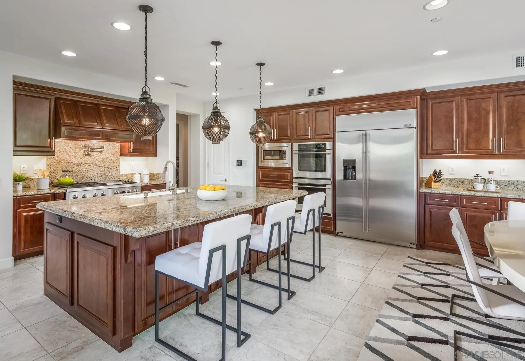 548 Quail Pointe Lane Encinitas, CA 92024 - Photo 9 of 30 a kitchen with granite countertop a table chairs window and stainless steel appliances