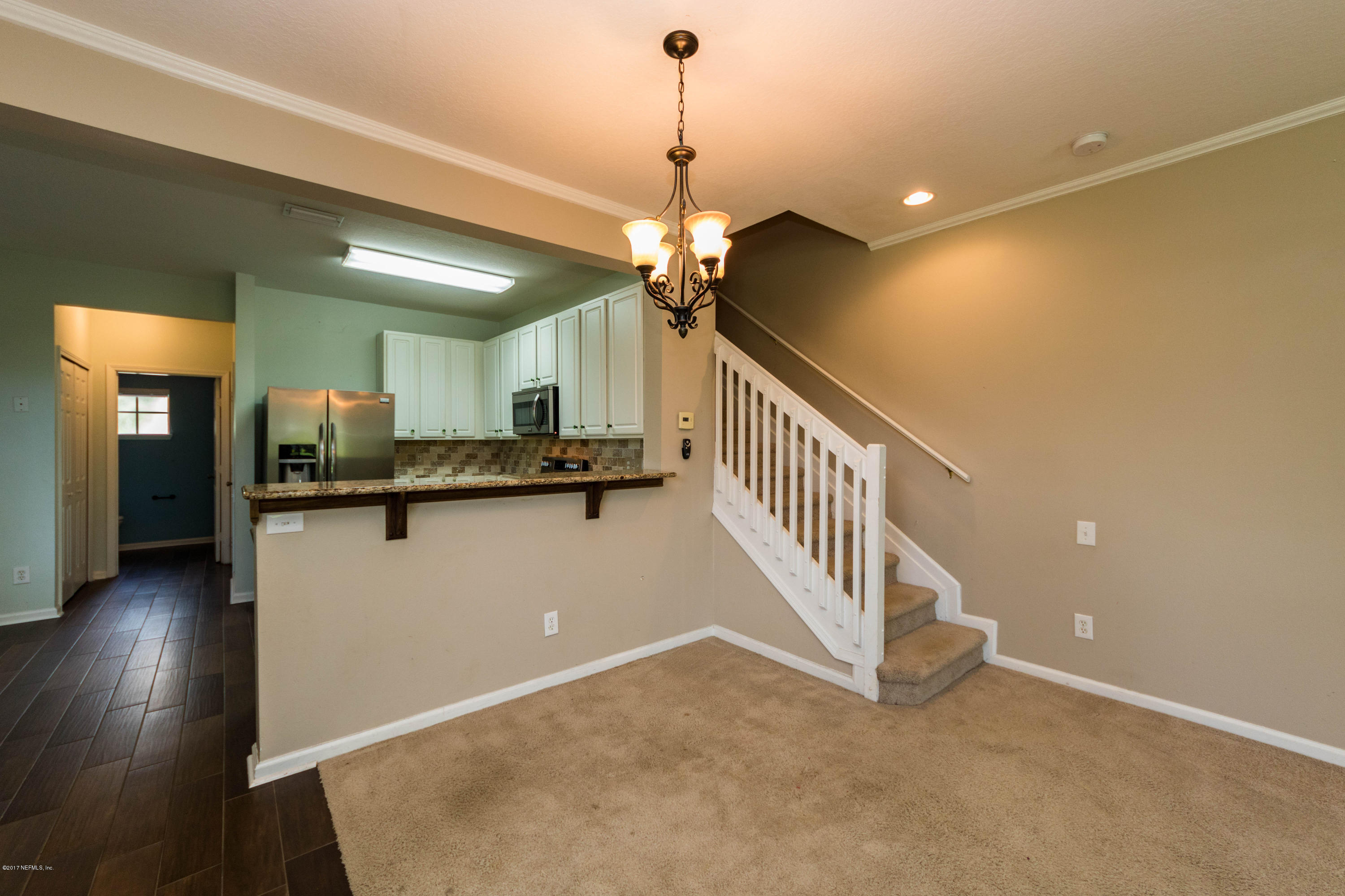 7990 Baymeadows Road East, Unit 1408 Jacksonville, FL 32256 - Photo 12 of 36 a view of a livingroom with a furniture stairs and a kitchen view