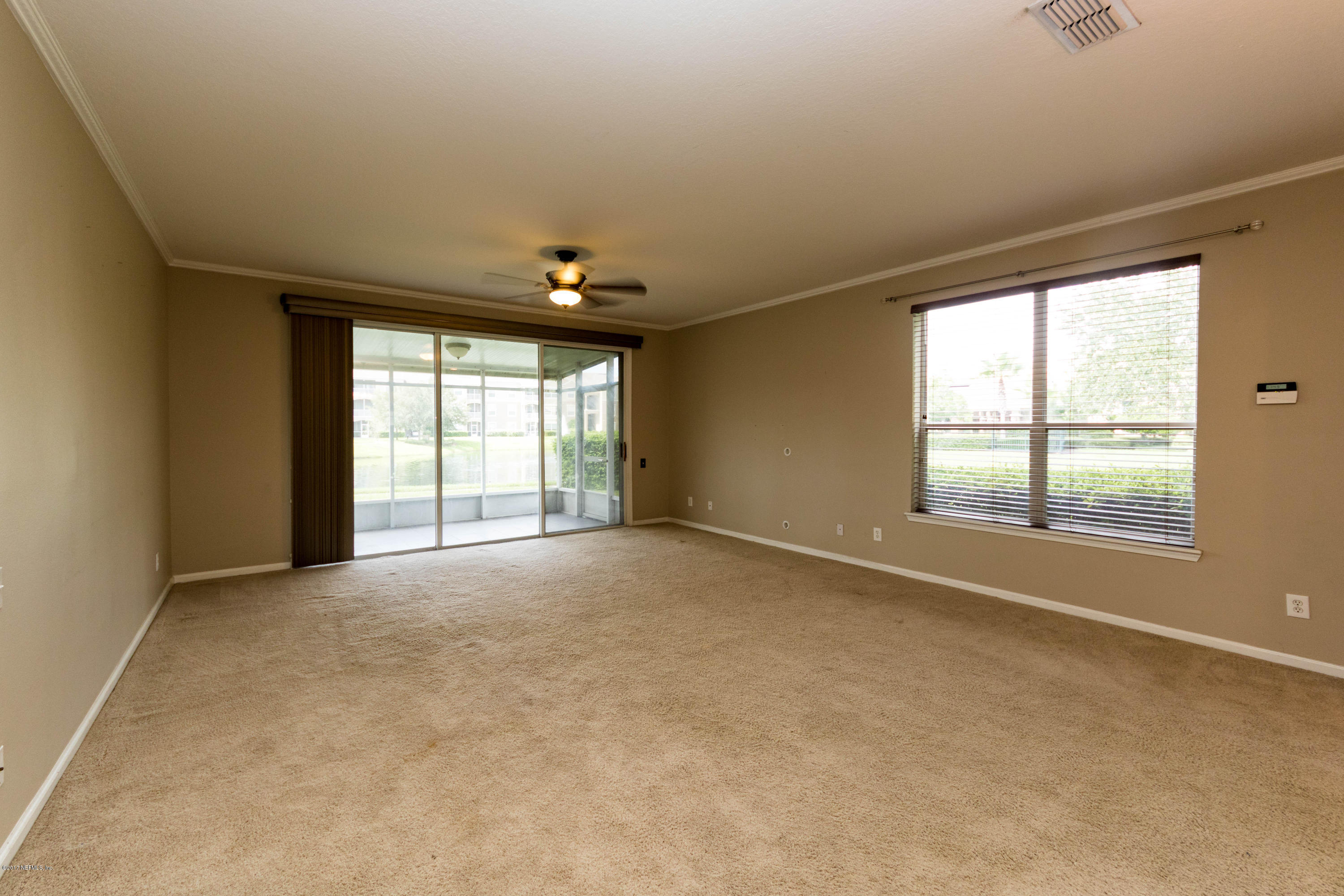7990 Baymeadows Road East, Unit 1408 Jacksonville, FL 32256 - Photo 14 of 36 an empty room with windows