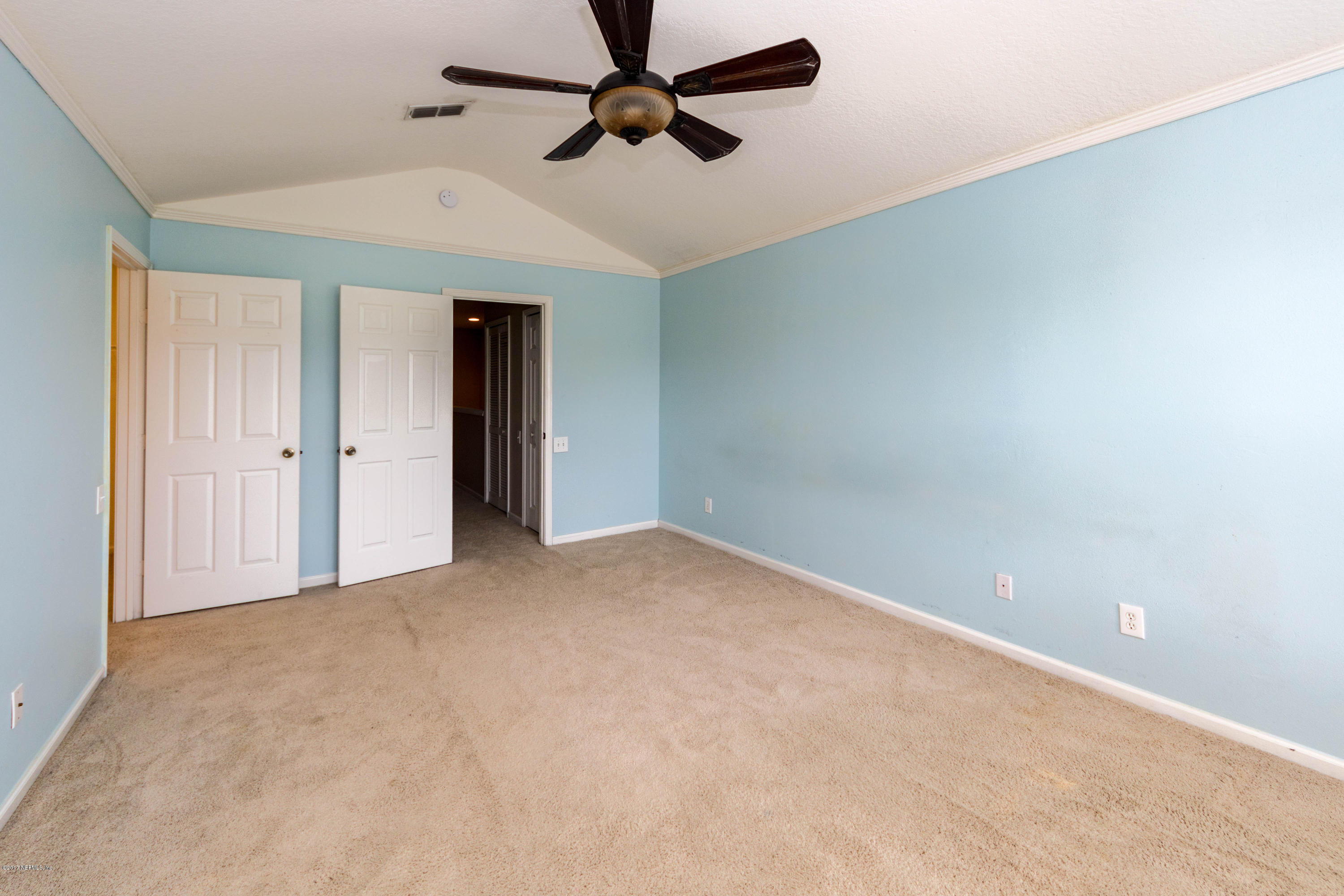 7990 Baymeadows Road East, Unit 1408 Jacksonville, FL 32256 - Photo 23 of 36 an empty room with closet and windows