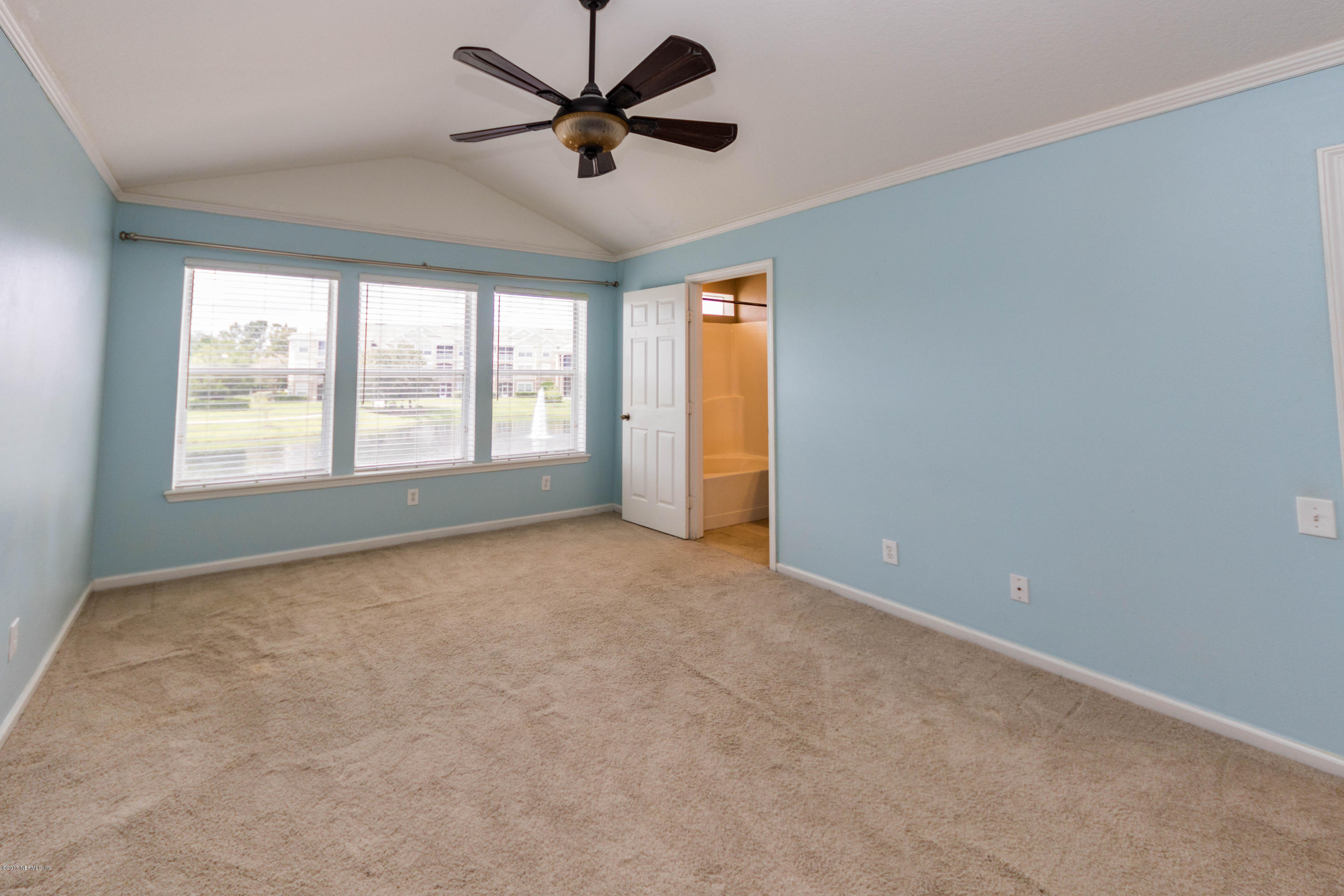 7990 Baymeadows Road East, Unit 1408 Jacksonville, FL 32256 - Photo 25 of 36 a view of a livingroom with a ceiling fan and window