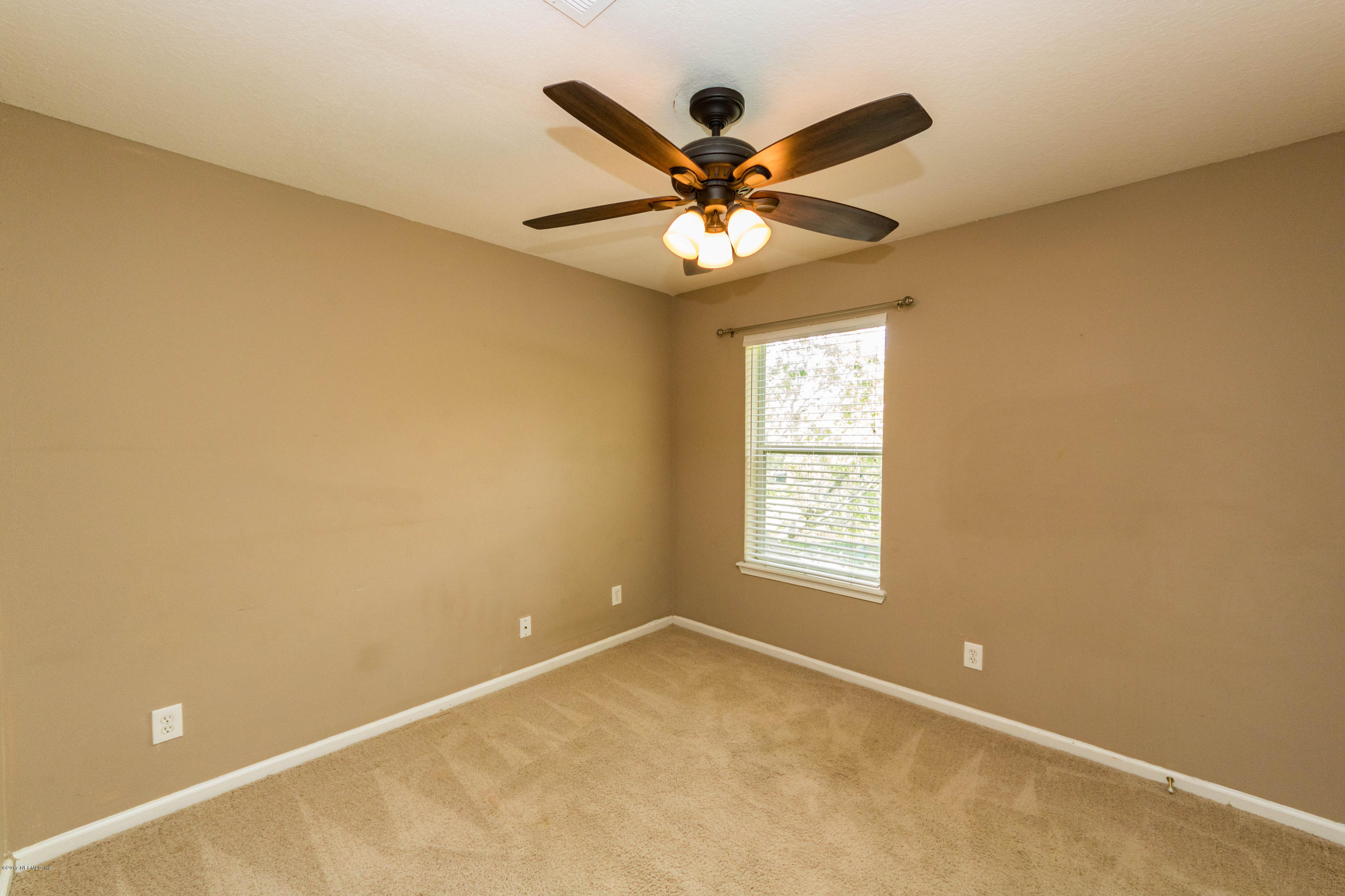 7990 Baymeadows Road East, Unit 1408 Jacksonville, FL 32256 - Photo 28 of 36 an empty room with windows and fan