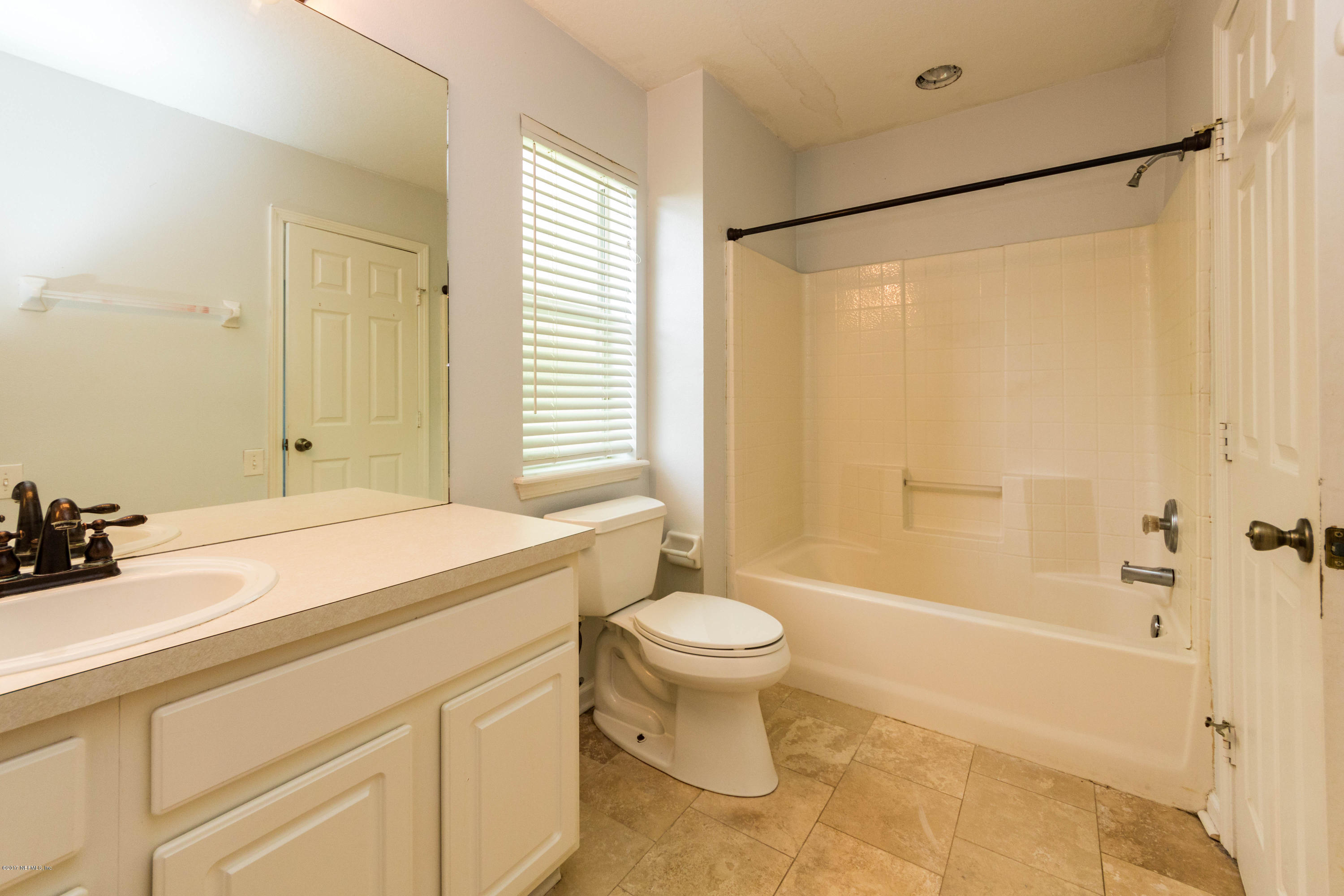 7990 Baymeadows Road East, Unit 1408 Jacksonville, FL 32256 - Photo 33 of 36 a bathroom with a sink toilet and shower
