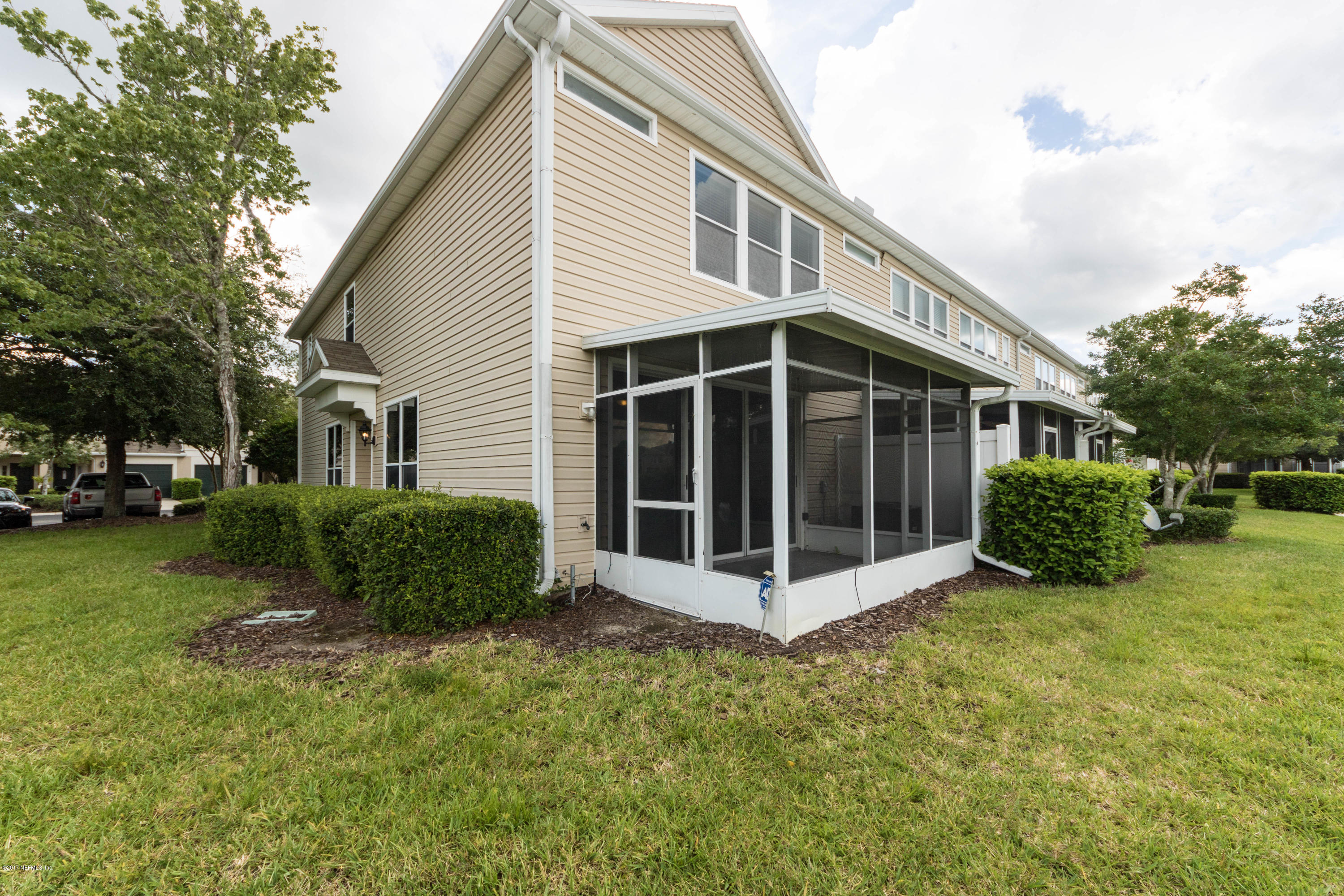 7990 Baymeadows Road East, Unit 1408 Jacksonville, FL 32256 - Photo 35 of 36 a view of a house with a yard and large trees