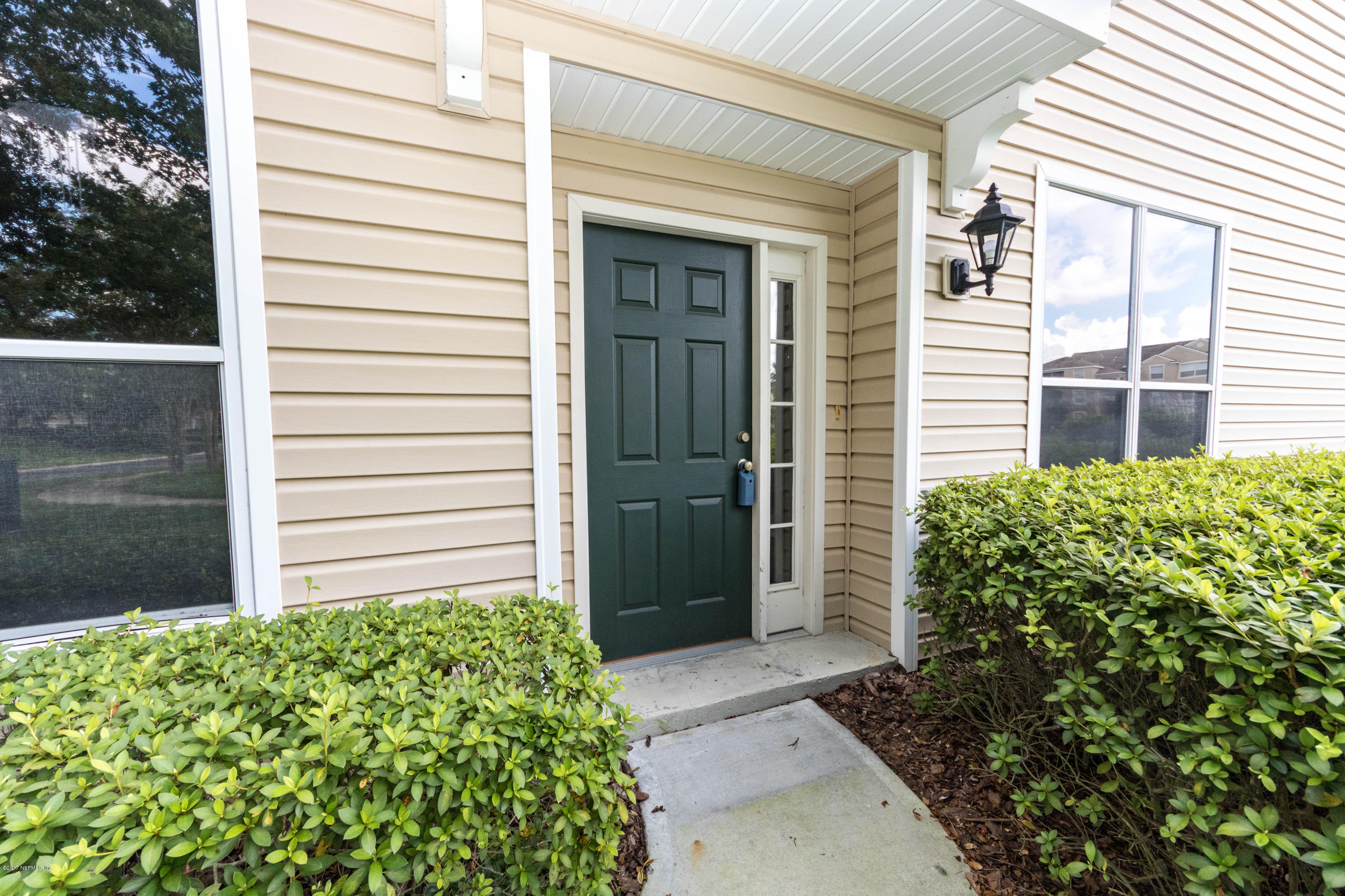 7990 Baymeadows Road East, Unit 1408 Jacksonville, FL 32256 - Photo 4 of 36 a front view of a house with garden