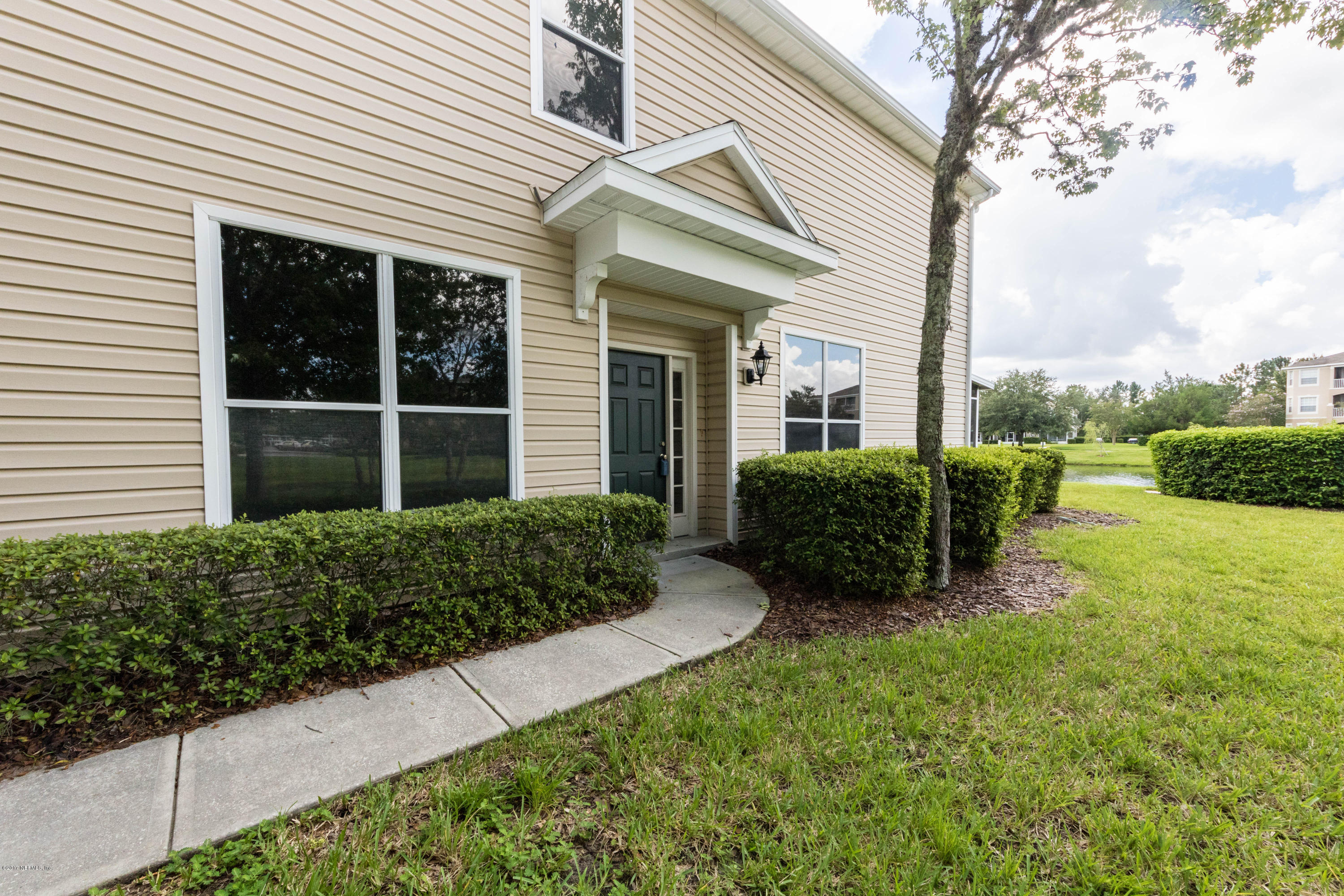 7990 Baymeadows Road East, Unit 1408 Jacksonville, FL 32256 - Photo 5 of 36 a view of a house with backyard and garden