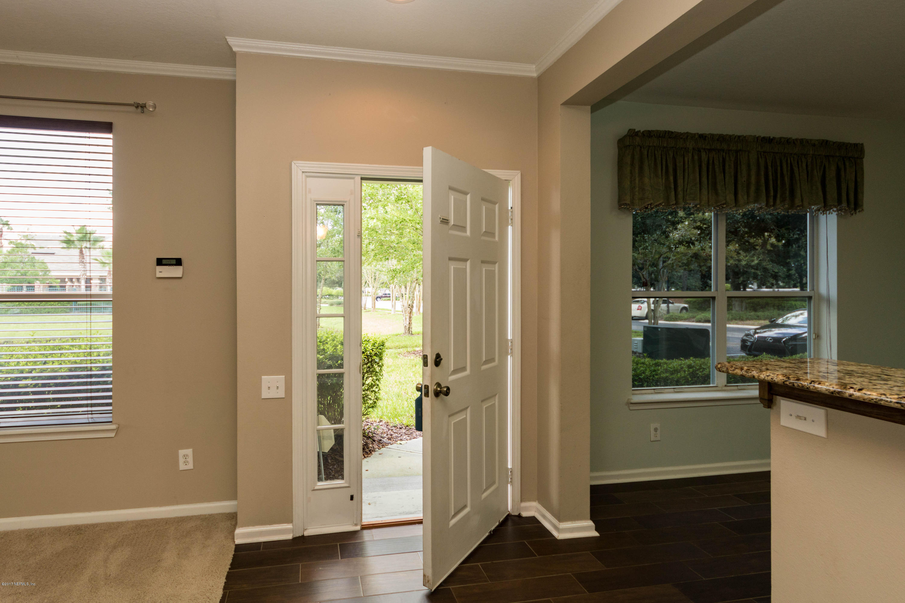 7990 Baymeadows Road East, Unit 1408 Jacksonville, FL 32256 - Photo 6 of 36 a view of a hallway with wooden floor and a living room