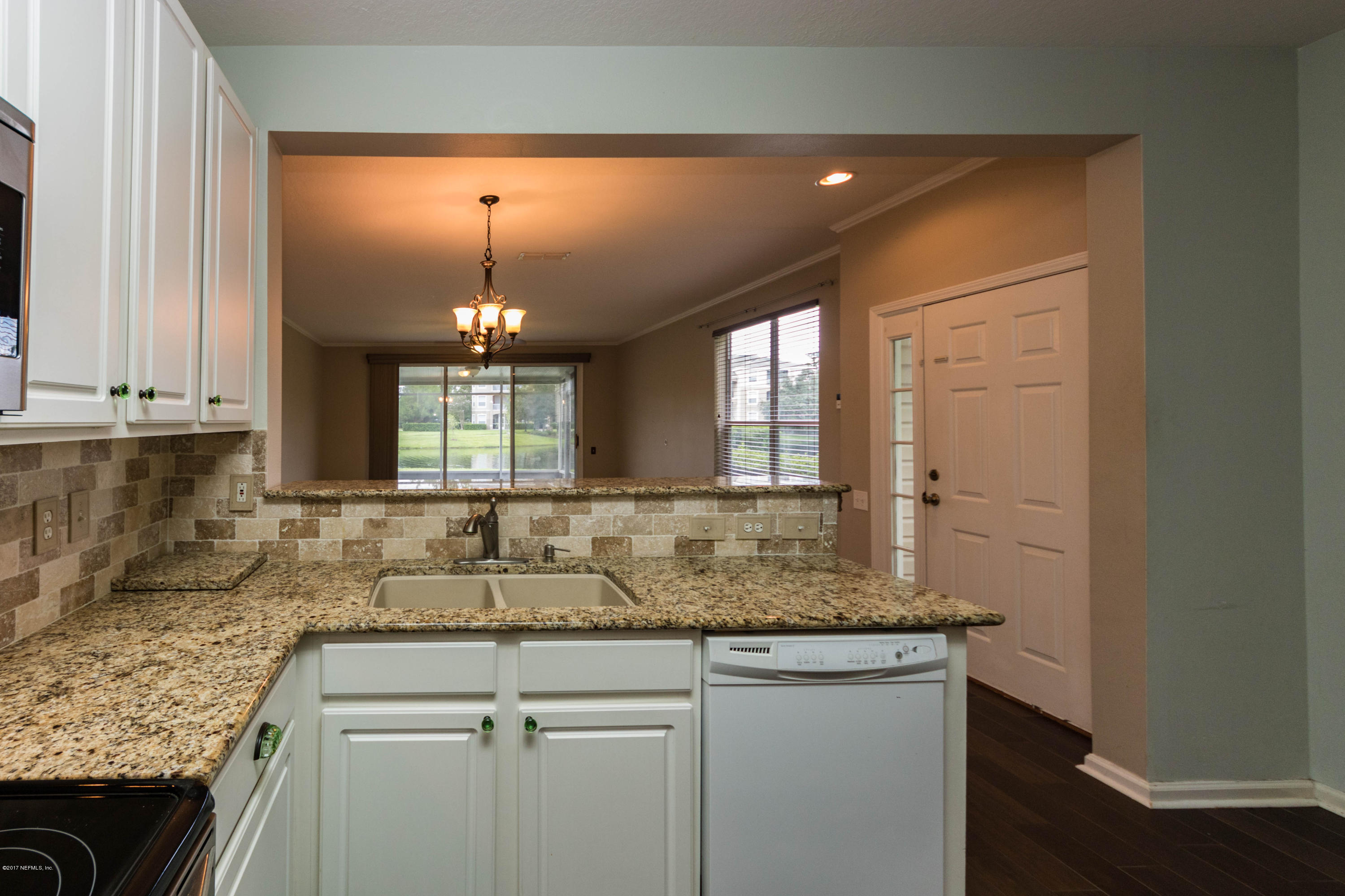 7990 Baymeadows Road East, Unit 1408 Jacksonville, FL 32256 - Photo 10 of 36 a kitchen with sink cabinets and window
