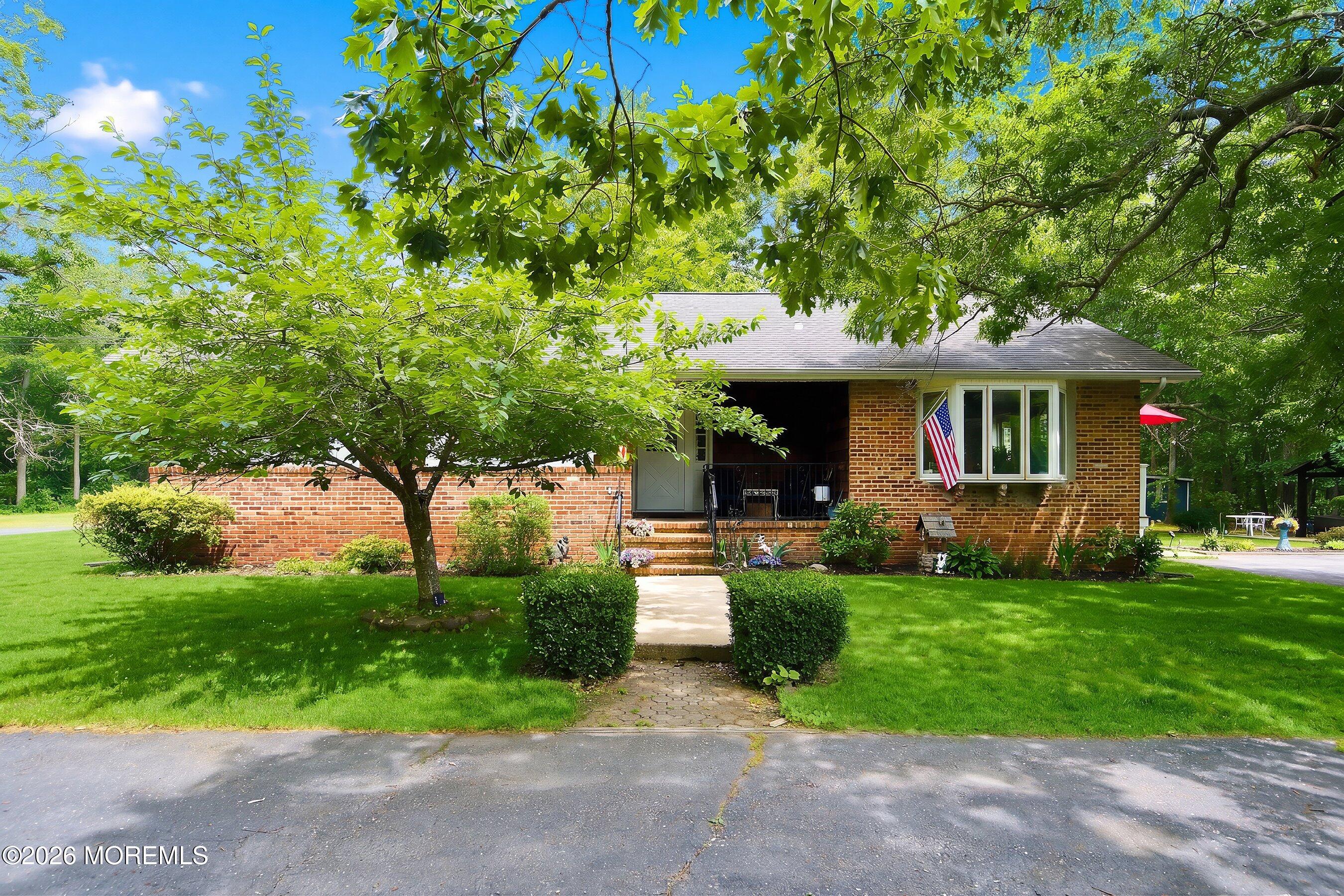 745 Oak Glen Road Howell, NJ 07731 - Photo 2 of 46 a front view of a house with garden