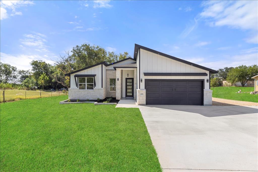 a front view of house with yard and green space