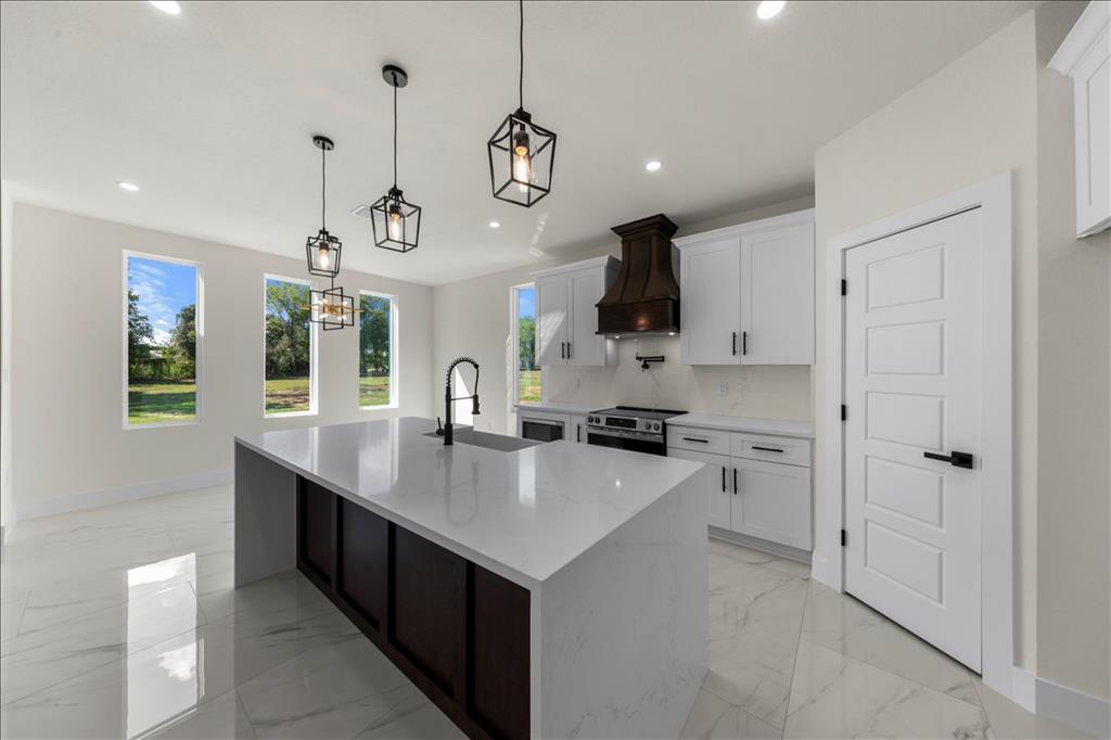 809 Fm 467 Seguin, TX 78155 - Photo 10 of 40 a kitchen with a stove a window and chairs