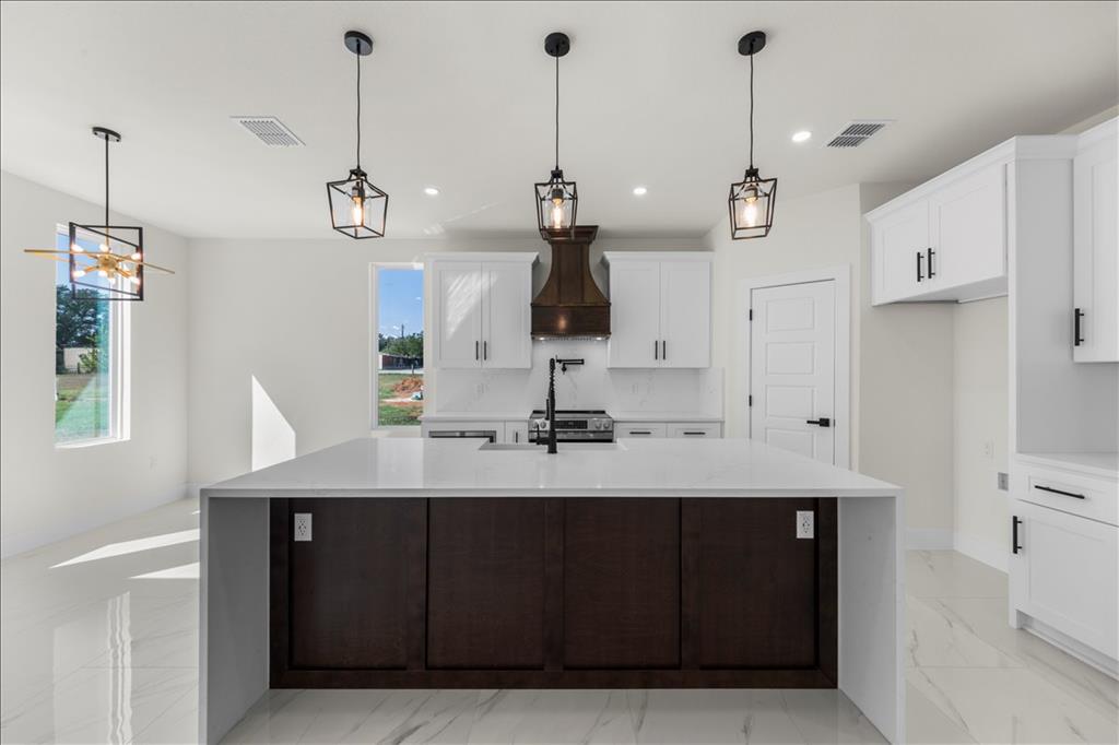 809 Fm 467 Seguin, TX 78155 - Photo 13 of 40 a view of a center kitchen sink and living room view