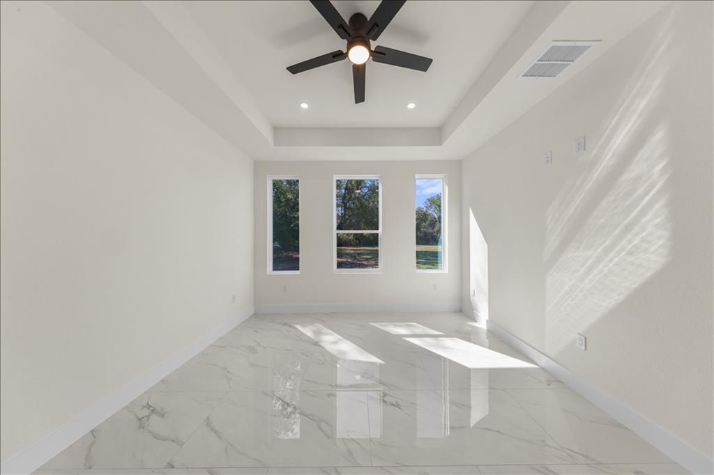 809 Fm 467 Seguin, TX 78155 - Photo 16 of 40 en empty room with windows and ceiling fan