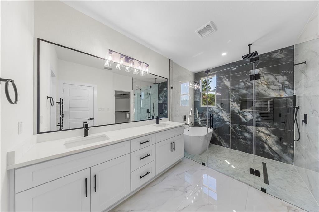 809 Fm 467 Seguin, TX 78155 - Photo 17 of 40 a bathroom with a double vanity sink toilet mirror and shower