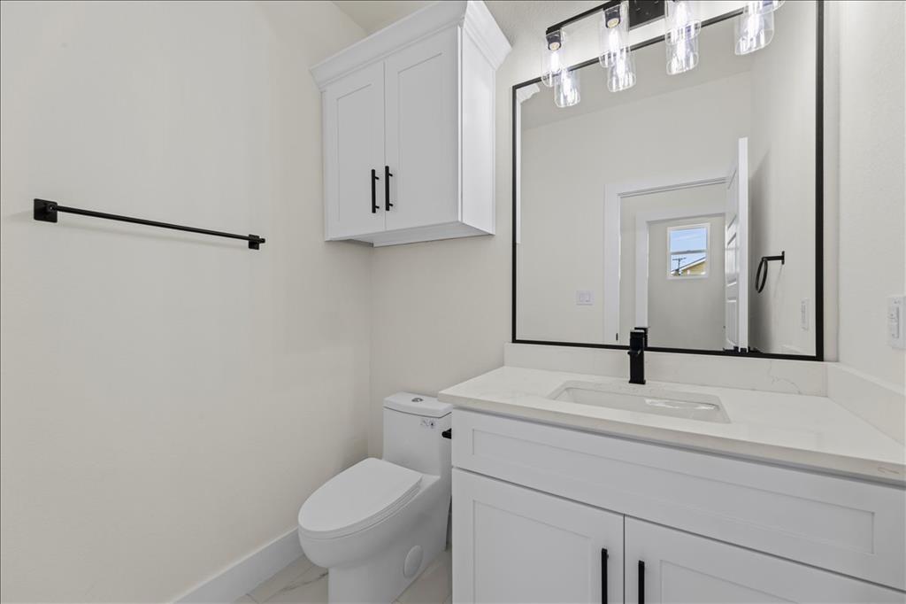 809 Fm 467 Seguin, TX 78155 - Photo 22 of 40 a bathroom with a granite countertop sink toilet and mirror