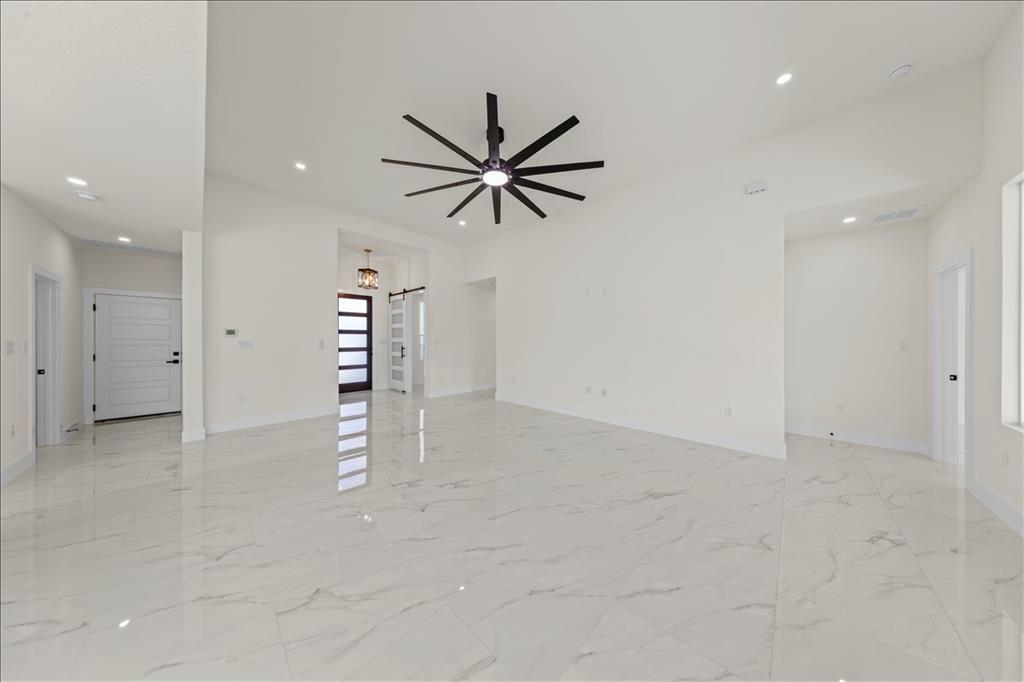 809 Fm 467 Seguin, TX 78155 - Photo 6 of 40 an empty room with chandelier fan and windows
