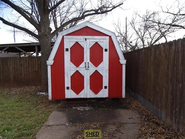 a view of a backyard with a tree