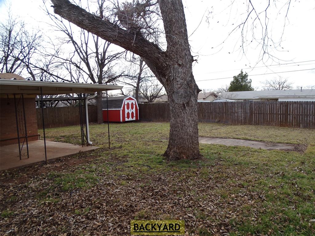 2002 Minter Lane Abilene, TX 79603 - Photo 16 of 16 a view of a backyard with a tree