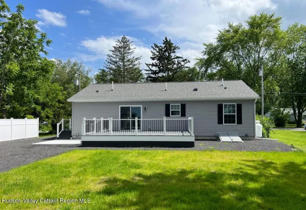 a front view of house with yard and trees