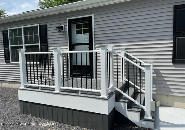 a view of a house with wooden fence