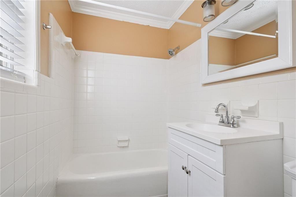 21 Delmont Drive Northeast, Unit 7 Atlanta, GA 30305 - Photo 12 of 22 a bathroom with a sink and a bathtub