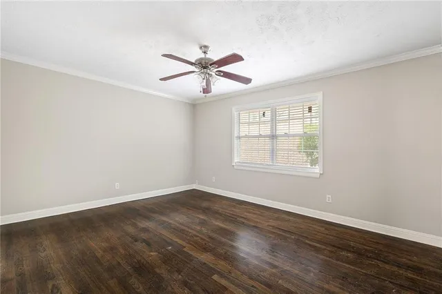 a view of a room with wooden floor and windows