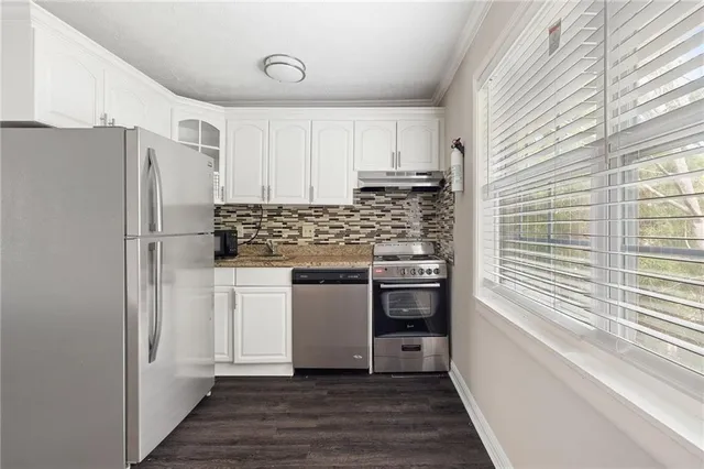 a kitchen with stainless steel appliances a refrigerator and a stove