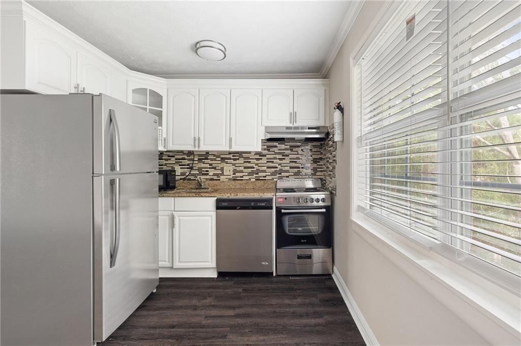 21 Delmont Drive Northeast, Unit 7 Atlanta, GA 30305 - Photo 18 of 22 a kitchen with stainless steel appliances a refrigerator and a stove