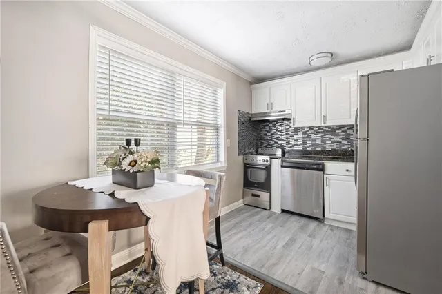 a kitchen with appliances cabinets and wooden floor