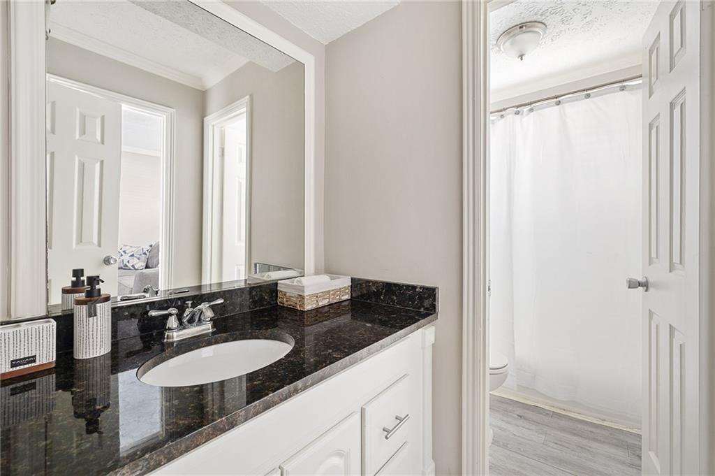 21 Delmont Drive Northeast, Unit 7 Atlanta, GA 30305 - Photo 7 of 22 a bathroom with a double vanity sink and a mirror