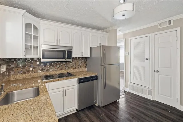 a kitchen with a refrigerator sink and microwave