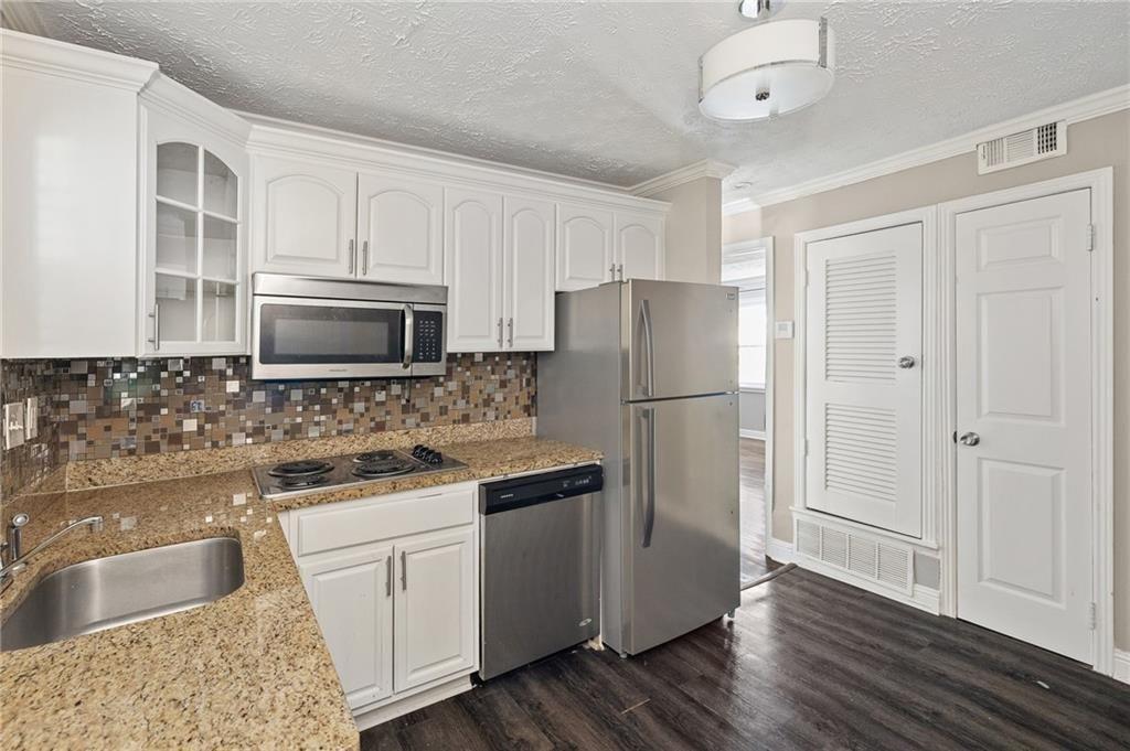 21 Delmont Drive Northeast, Unit 7 Atlanta, GA 30305 - Photo 10 of 22 a kitchen with a refrigerator sink and microwave