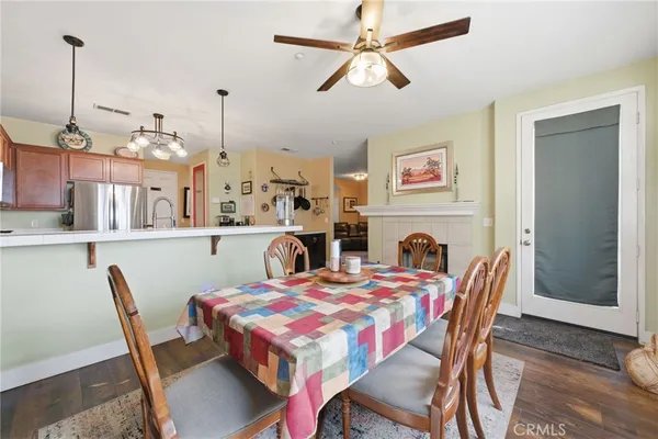 a kitchen with stainless steel appliances granite countertop a sink a stove and a wooden floors