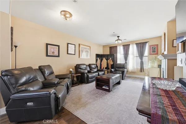 a living room with couches and a chandelier