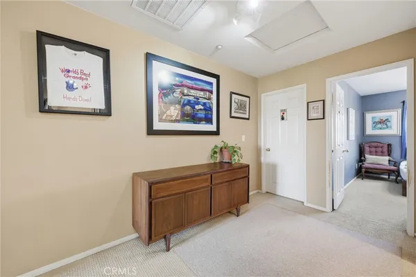 a bedroom with a bed and a lamp on dresser
