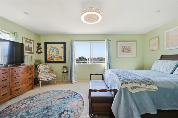 a bedroom with a bed and flat screen tv