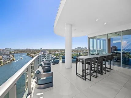 a view of a dining room with furniture and a large window