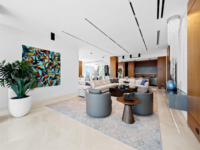 a bedroom with a bed couch and a flat screen tv