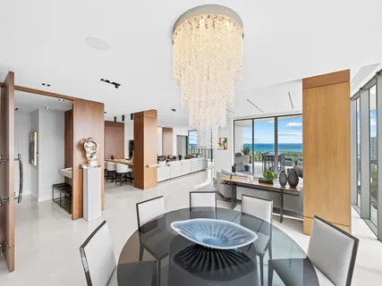 a spacious bedroom with a bed a couch and a potted plant