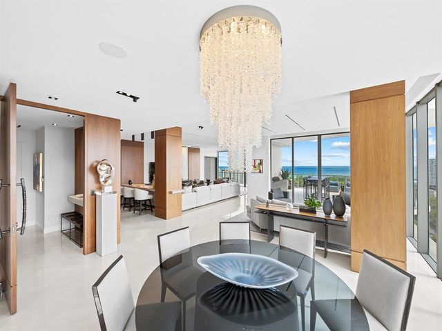 a spacious bedroom with a bed a couch and a potted plant