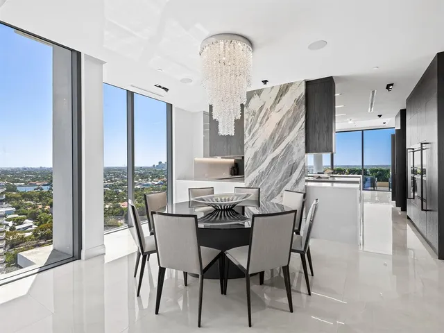 a bathroom with a toilet a sink a mirror and shower