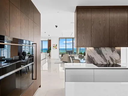 a living room with furniture city view and a floor to ceiling window