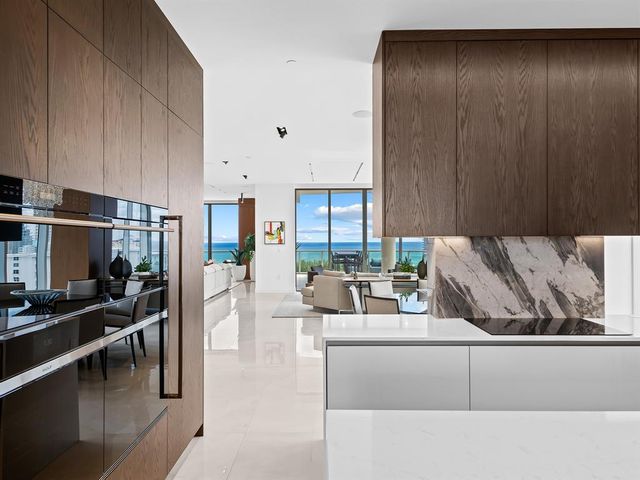 a living room with furniture city view and a floor to ceiling window