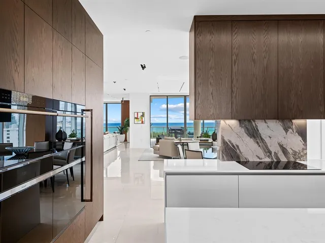 a living room with furniture city view and a floor to ceiling window