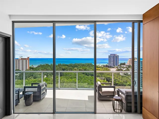 a view of roof deck with seating area and water view