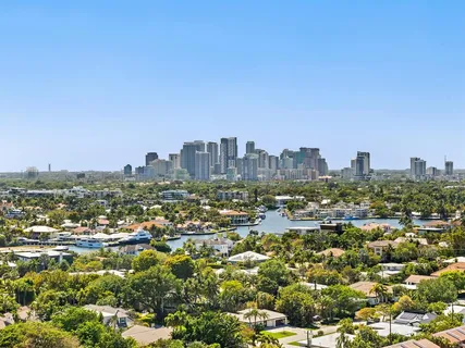 a view of swimming pool with outdoor seating and city view