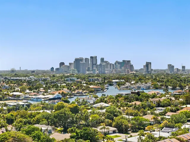 a view of swimming pool with outdoor seating and city view