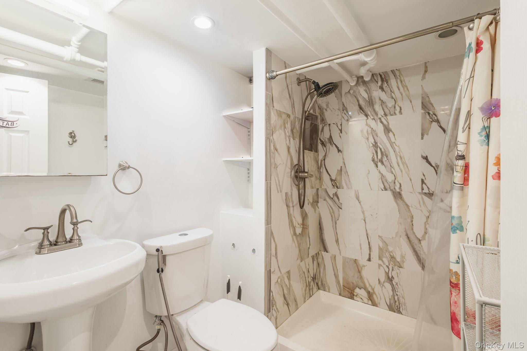 50 Acorn Terrace New Rochelle, NY 10801 - Photo 26 of 27 a bathroom with a sink toilet and shower