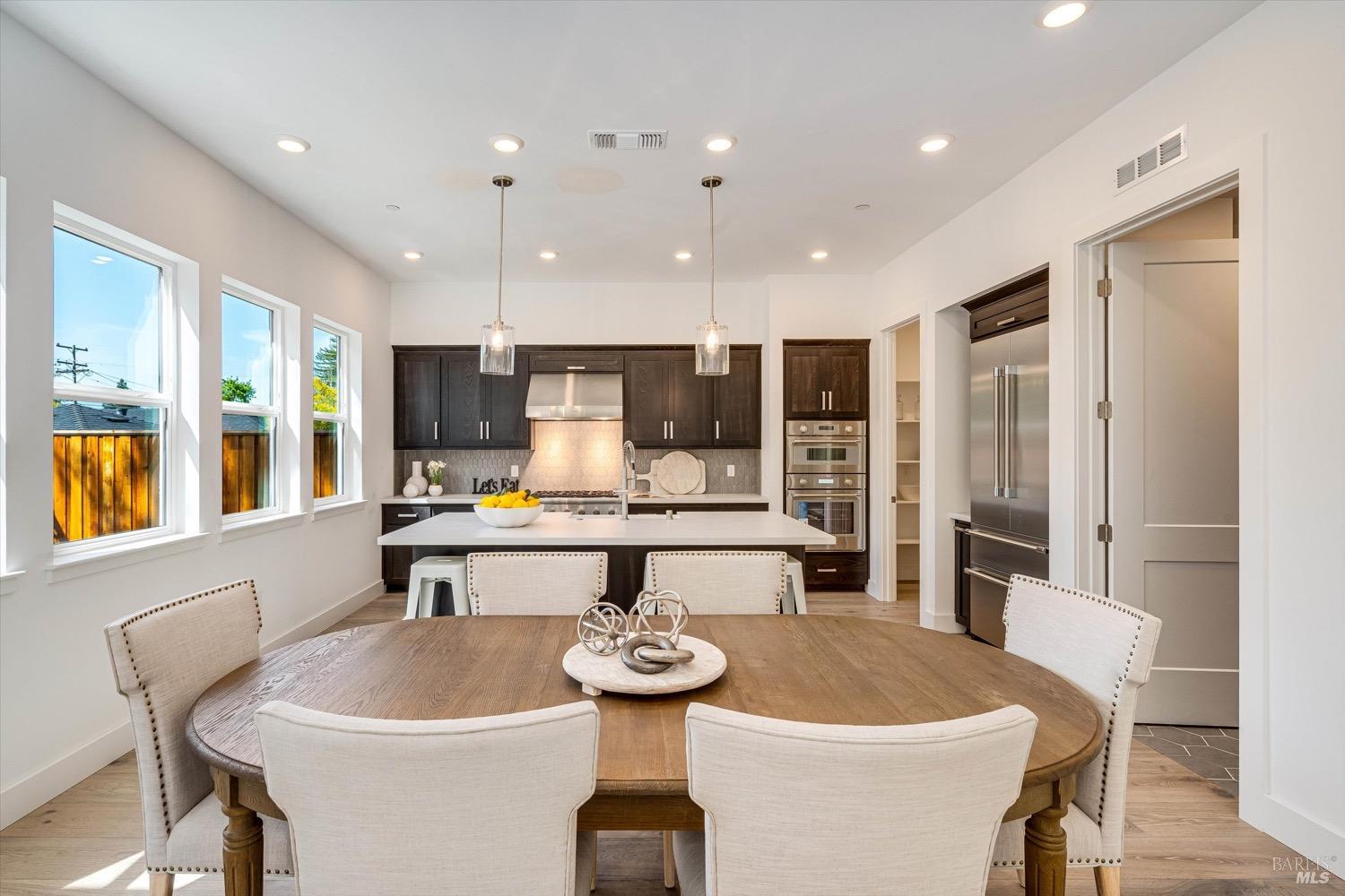 103 Grace Lane Napa, CA 94559 - Photo 16 of 39 a large dining hall with stainless steel appliances kitchen island a table and chairs
